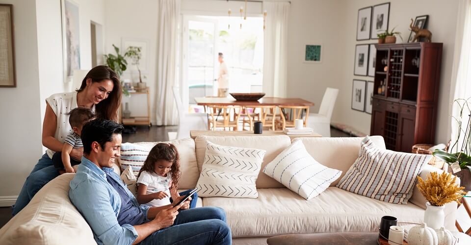 A woman and a girl are sitting on the couch